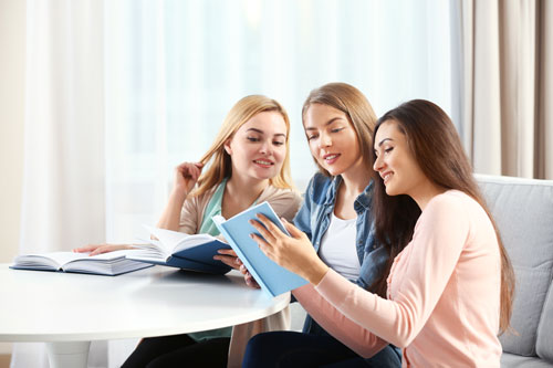 Girls Reading at Table